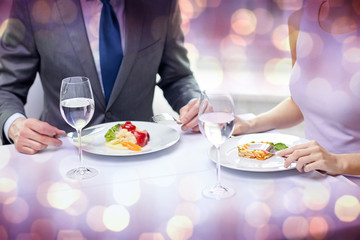 close up of couple eating appetizers at restaurant