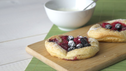 Sweet cakes with berries on table close-up