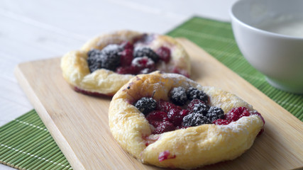 Sweet cakes with berries on table close-up