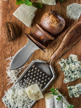 Different types of cheeses with nuts and herbs.