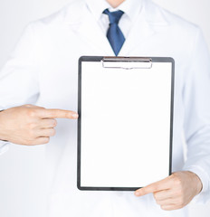 doctor pointing at blank white paper