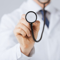 doctor hand with stethoscope listening something