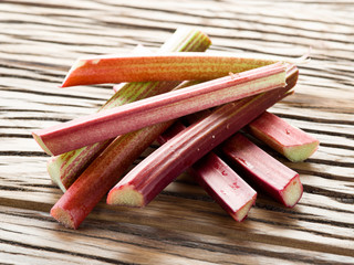 Rhubarb stalks on the wooden table.