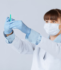 female doctor holding syringe with injection