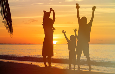 happy family with two kids having fun at sunset