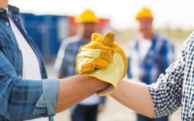 close up of builders hands making handshake