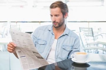 Young man reading the newspapers