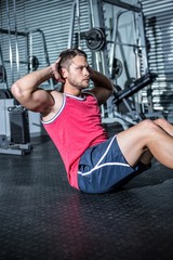 Muscular man doing sit-ups 