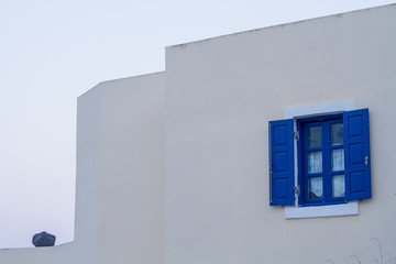Blue window on traditional santorini house.