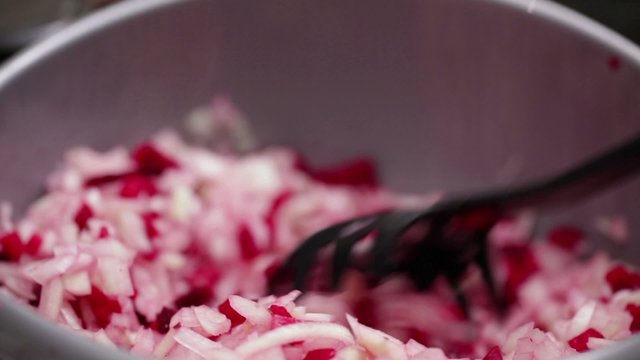 HD 1080:  spanish onions finely chopped, salted; close up