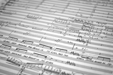 Music manuscript. Close, full-frame detail of an orchestral sore complete with notation and conductors markings.