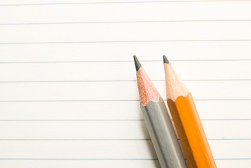 Opened notebook and pencils on the old tissue