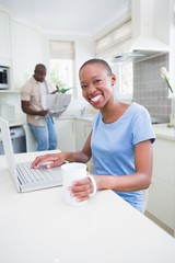 Obraz premium Portrait of a happy smiling pretty woman using her laptop