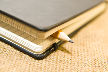 notebook and pencil on the old tissue