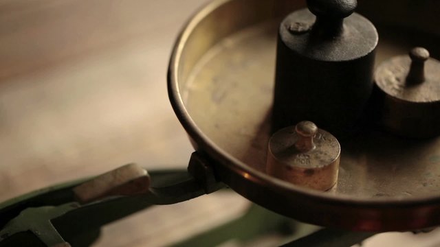 Weighting - vintage scale with iron weights; close up