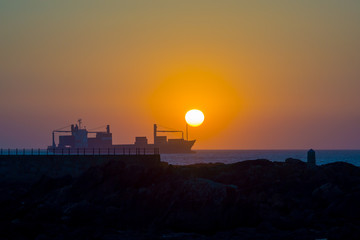 Cargo ship at sunset