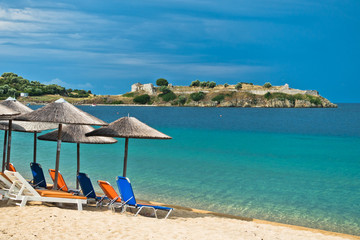 Beachscape with orange chairs and straw sunshades, Sithonia