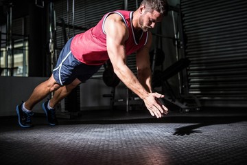 Muscular man doing push-ups with hand clapping 