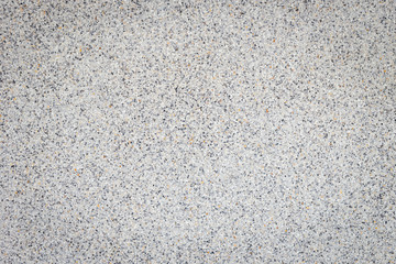 Bright grey pebble stone wall texture and background