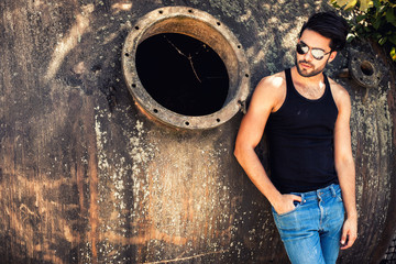 handsome man model dressed punk, hipster posing dramatic in grun