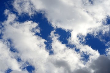 Big fluffy white and dark clouds in the blue sky