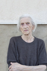 Portrait of a ninety years old grandma with walking stick outdoo