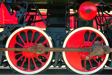 Red locomotive wheel with black mechanisms