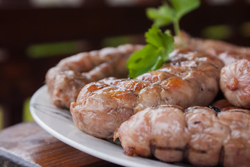 Fototapeta na wymiar Grilled sausages closeup on a plate