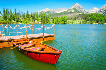 Red wooden boats on mountain lake, Slovakia Europe