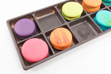 Macaron in tray on white background.