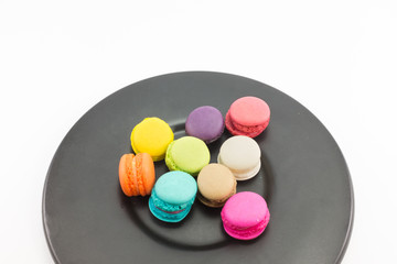 Fototapeta na wymiar Colorful macaron in black plate on white background.
