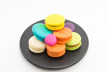 Macaron in plate on white background.