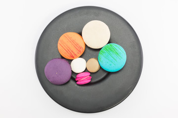 Macaron in plate on white background.
