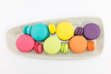 Macaron in plate on white background.