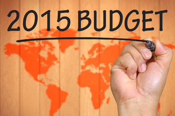 blur world background and hand writing 2015 budget