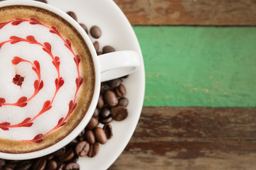 Latte art, coffee with coffee beans on wooden  background