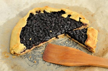 Delicious vegan galette with wild blueberry cut with wooden spat