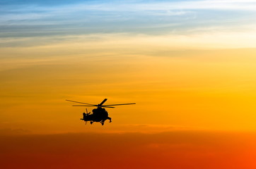 silhouette of the helicopter at sunset