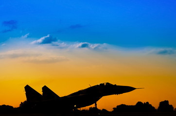 Fototapeta na wymiar silhouette of military aircraft on takeoff