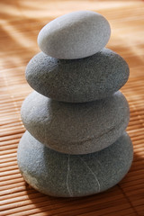 Obraz na płótnie Canvas balanced stones on wooden background
