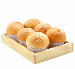 Fresh buns on a wooden tray isolated
