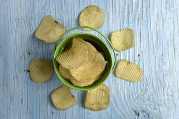 Potato chips on old wooden table