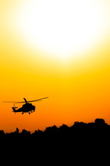 Fototapeta na wymiar silhouette of military helicopter above the ground