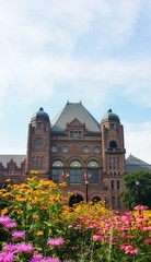 Fototapeta na wymiar Ontario Legislative Building and summer flowers