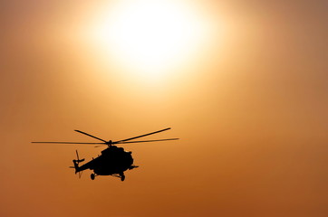 Fototapeta na wymiar silhouette of a helicopter in the sun