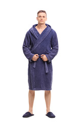 Young man posing in a blue bathrobe