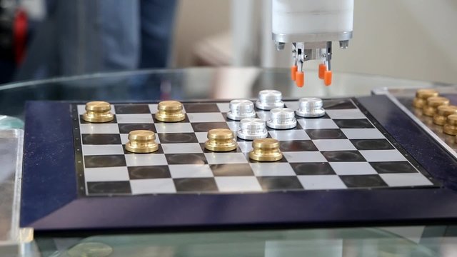 Robot plays checkers with myself at the exhibition