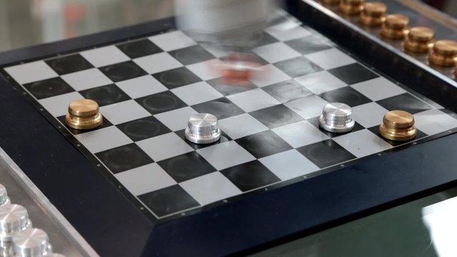 Robot plays checkers with myself at the exhibition