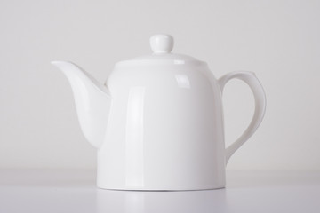 white ceramic teapot on white background	