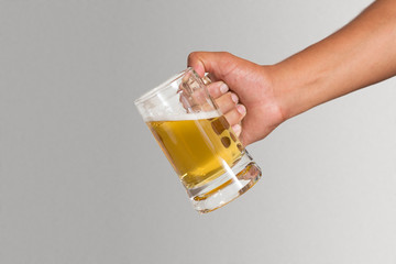 Hand holding a glass of beer